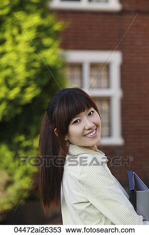 Portrait of Chinese woman smiling in front of University View Large Photo Image Stock Image - Portrait of Chinese woman smiling in front of University. Fotosearch