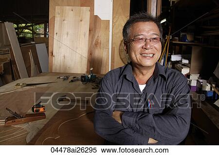 Smiling mature man in front of his work bench. View Large Photo Image Stock Photography - Smiling mature man in front of his work bench.. Fotosearch