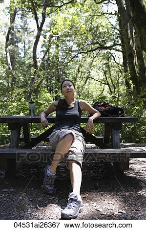 woman sitting at picnic table View Large Photo Image Stock Photo - woman sitting at picnic table. Fotosearch