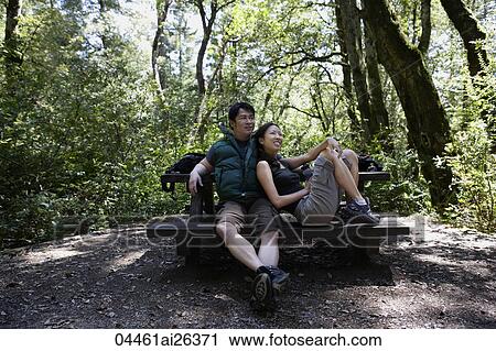 young couple sitting at picnic table View Large Photo Image Stock Image - young couple sitting at picnic table. Fotosearch