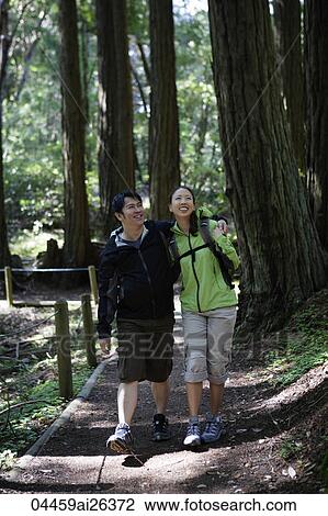 Young couple walking through redwood forest View Large Photo Image Stock Image - Young couple walking through redwood forest. Fotosearch