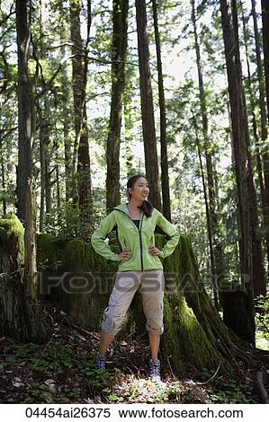 Young woman taking enjoying view in woods View Large Photo Image Stock Photography - Young woman taking enjoying view in woods. Fotosearch