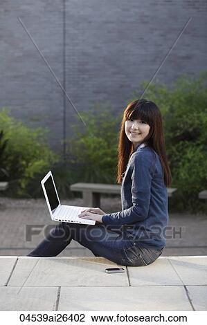 Asian woman working on laptop outside. View Large Photo Image Stock Image - Asian woman working on laptop outside.. Fotosearch