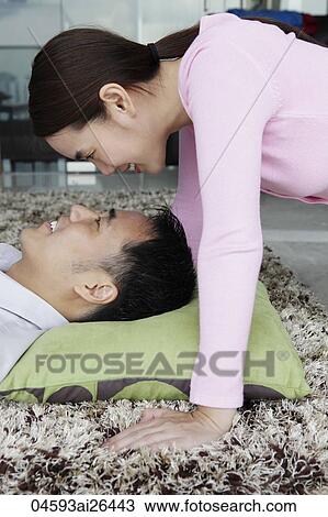 Close up of couple looking at each other smiling View Large Photo Image Stock Image - Close up of couple looking at each other smiling. Fotosearch