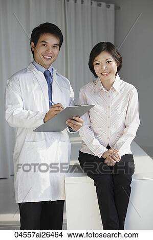 Doctor checking female patient View Large Photo Image Picture - Doctor checking female patient. Fotosearch