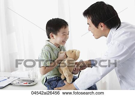 Doctor laughing with young boy View Large Photo Image Stock Photograph - Doctor laughing with young boy. Fotosearch