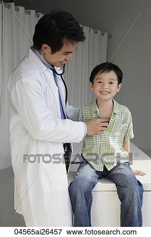 Stock Photo - Doctor listening to young boy's heart. Fotosearch