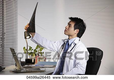 Doctor looking at X ray. View Large Photo Image Stock Photography - Doctor looking at X ray.. Fotosearch
