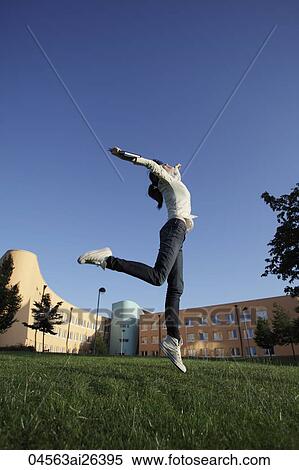 Happy Asian woman jumping in air. View Large Photo Image Stock Photography - Happy Asian woman jumping in air.. Fotosearch