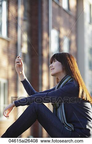 Profile of Asian woman looking at phone. View Large Photo Image Stock Photo - Profile of Asian woman looking at phone.. Fotosearch