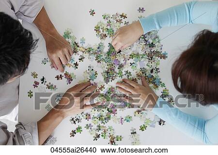 top view of couple putting puzzle together View Large Photo Image Stock Image - top view of couple putting puzzle together. Fotosearch