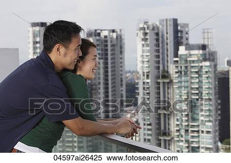 Young couple hugging and looking at view View Large Photo Image Stock Photography - Young couple hugging and looking at view. Fotosearch