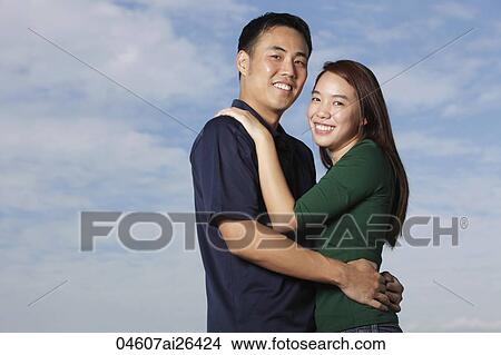 Young couple hugging and smiling View Large Photo Image Picture - Young couple hugging and smiling. Fotosearch