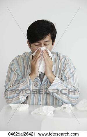 Young man blowing his nose, sneezing View Large Photo Image Stock Image - Young man blowing his nose, sneezing. Fotosearch