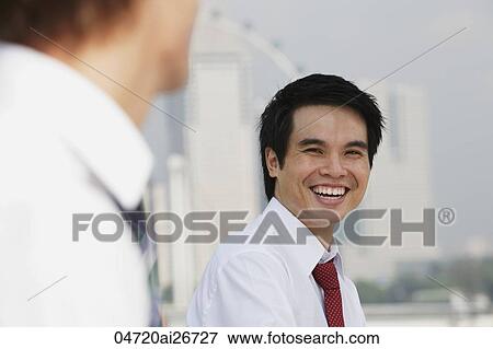 Business man laughing at another man View Large Photo Image Stock Photo - Business man laughing at another man. Fotosearch