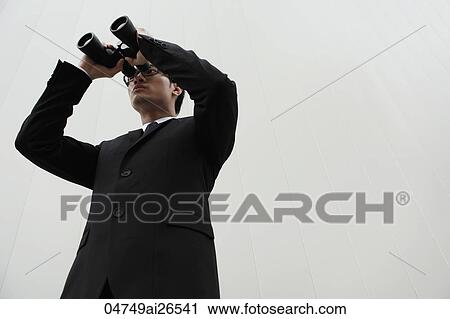 Business man looking through binoculars View Large Photo Image Stock Image - Business man looking through binoculars. Fotosearch