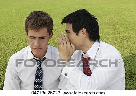 Stock Image - Business man whispering to another man. Fotosearch