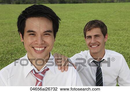 Stock Image - business man with hand on shoulder of another man. Fotosearch