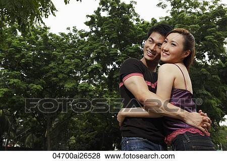 Chinese couple hugging each other and smiling View Large Photo Image Stock Photo - Chinese couple hugging each other and smiling. Fotosearch