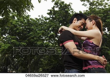 Chinese couple hugging each other View Large Photo Image Stock Photo - Chinese couple hugging each other. Fotosearch