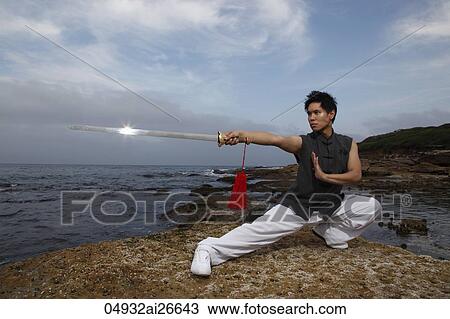 Chinese man doing martial arts and pointing sword View Large Photo Image Stock Image - Chinese man doing martial arts and pointing sword. Fotosearch