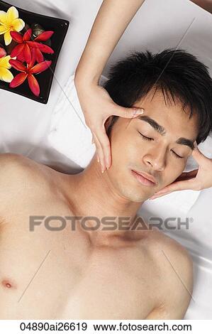 Stock Photo - Chinese man getting a face massage. Fotosearch