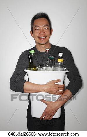 Chinese man holding a bucket of bottles to recycle View Large Photo Image Stock Image - Chinese man holding a bucket of bottles to recycle. Fotosearch