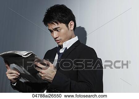 Chinese man holding newspaper looking shocked View Large Photo Image Stock Image - Chinese man holding newspaper looking shocked. Fotosearch