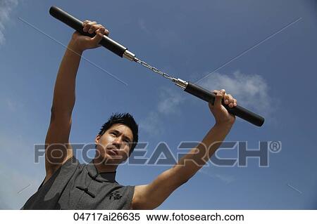 Chinese man holding nunchucks View Large Photo Image Stock Photography - Chinese man holding nunchucks. Fotosearch