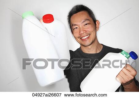 Chinese man holding plastic bottles to recycle View Large Photo Image Stock Photo - Chinese man holding plastic bottles to recycle. Fotosearch