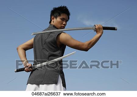 Stock Photo - Chinese man holding sword behind his back. Fotosearch