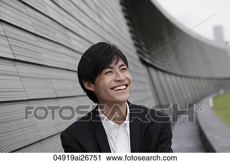 Stock Image - Chinese man laughing out side. Fotosearch