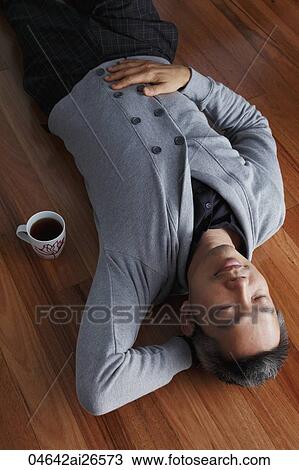 Chinese man laying on floor relaxing View Large Photo Image Stock Image - Chinese man laying on floor relaxing. Fotosearch