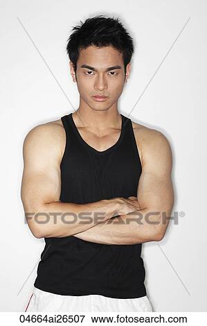 Stock Photo - Chinese man looking at camera with arms folded. Fotosearch