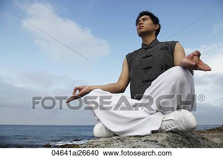 Chinese man meditating on rock View Large Photo Image Stock Image - Chinese man meditating on rock. Fotosearch