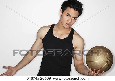 Stock Photo - Chinese man playing with basketball. Fotosearch