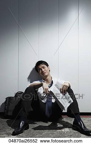Chinese man sitting on ground holding newspaper and looking sad View Large Photo Image Stock Image - Chinese man sitting on ground holding newspaper and looking sad. Fotosearch