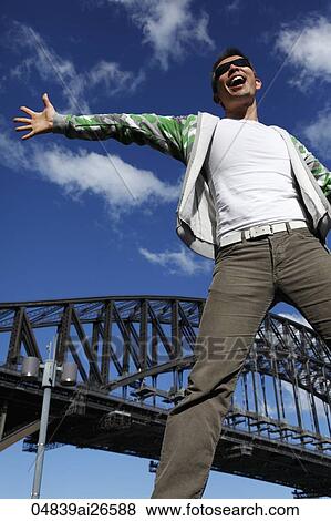 Chinese man smiling with and jumping with arms outstretched View Large Photo Image Stock Photo - Chinese man smiling with and jumping with arms outstretched. Fotosearch