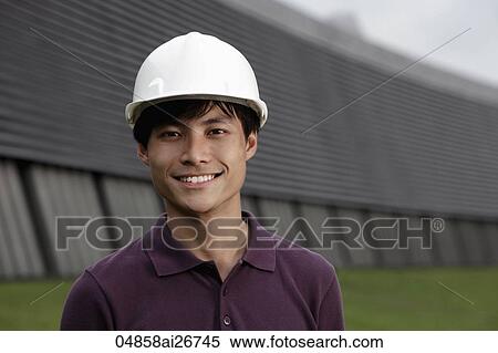 Chinese man wearing construction hat smiling View Large Photo Image Stock Photography - Chinese man wearing construction hat smiling. Fotosearch