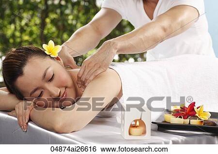 Stock Photograph - Chinese woman getting a back massage. Fotosearch