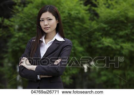 Chinese woman looking at camera with arms folder outside View Large Photo Image Stock Image - Chinese woman looking at camera with arms folder outside. Fotosearch