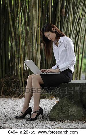 Chinese woman working on lap top in bamboo garden View Large Photo Image Stock Photography - Chinese woman working on lap top in bamboo garden. Fotosearch
