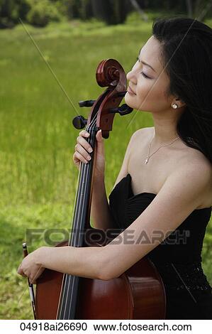 Close up of woman holding cello View Large Photo Image Stock Image - Close up of woman holding cello. Fotosearch