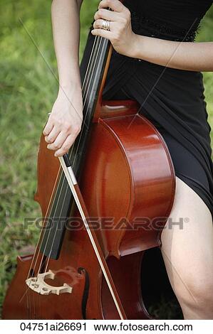 Cropped photo of hands playing cello View Large Photo Image Stock Image - Cropped photo of hands playing cello. Fotosearch