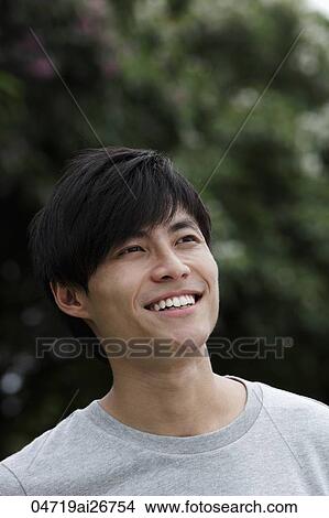 Head shot of Chinese man smiling and looking up View Large Photo Image Picture - Head shot of Chinese man smiling and looking up. Fotosearch