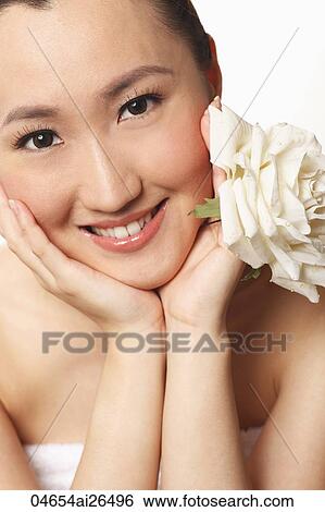 Head shot of Chinese woman holding flower View Large Photo Image Stock Photograph - Head shot of Chinese woman holding flower. Fotosearch