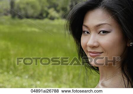 Head shot of Chinese woman looking at camera outside View Large Photo Image Stock Photo - Head shot of Chinese woman looking at camera outside. Fotosearch