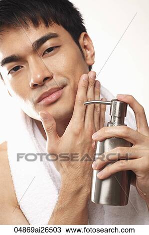 Stock Image - Head shot of man washing his face. Fotosearch