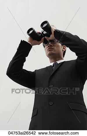 Man looking through binoculars View Large Photo Image Stock Image - Man looking through binoculars. Fotosearch