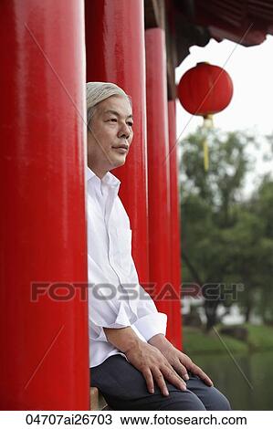 Older man sitting down at Chinese temple View Large Photo Image Stock Image - Older man sitting down at Chinese temple. Fotosearch